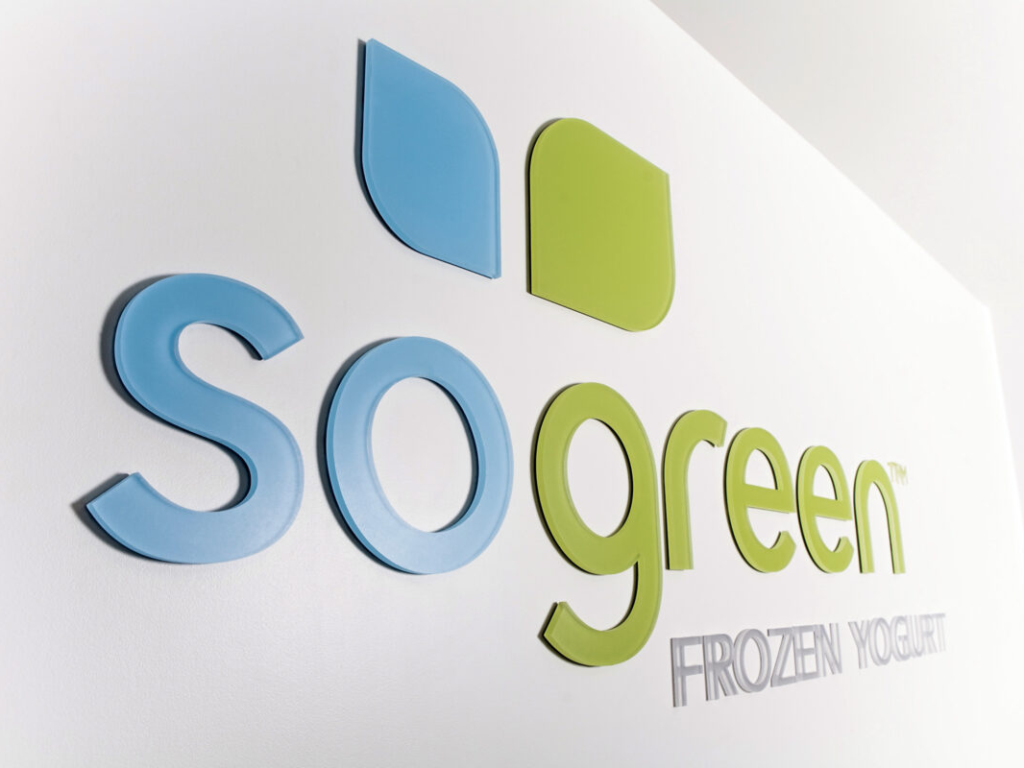 Custom acrylic cut letters mounted on an interior wall for branded office signage and logo displays.