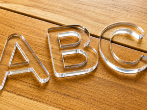 Clear acrylic cut letters showing polished edges, dimensional depth, and custom fabrication details for signage applications.