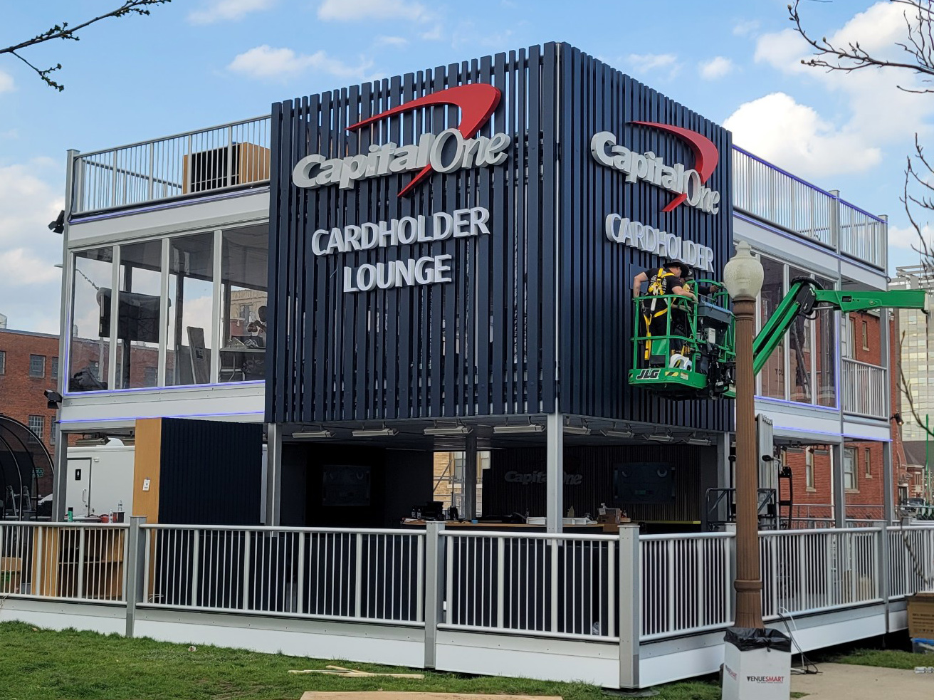 Large illuminated channel letter signage installed on a Capital One event structure for corporate branding and experiential marketing.