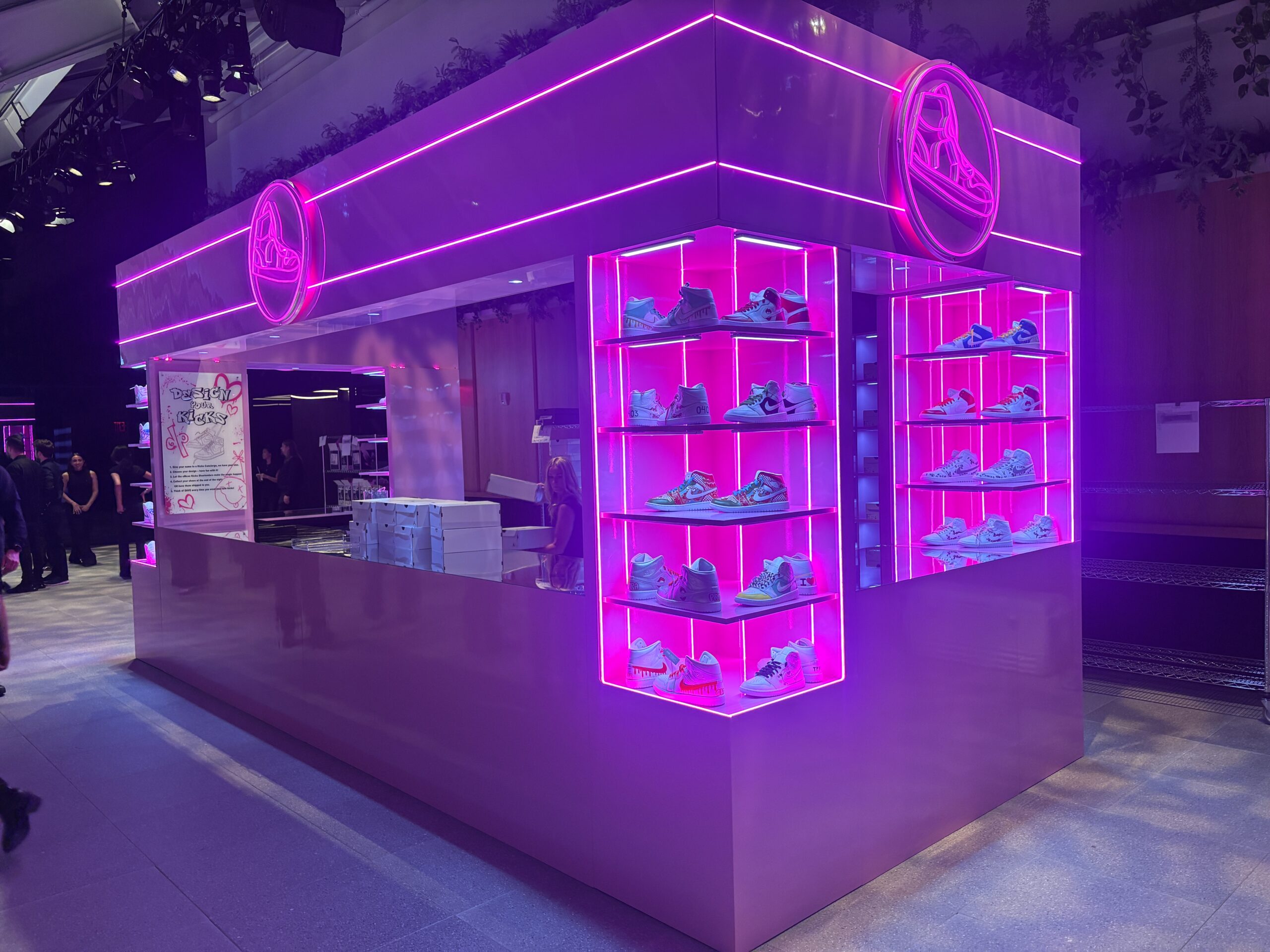 Pink LED neon sneaker logo sign installed at a retail event and branded activation.