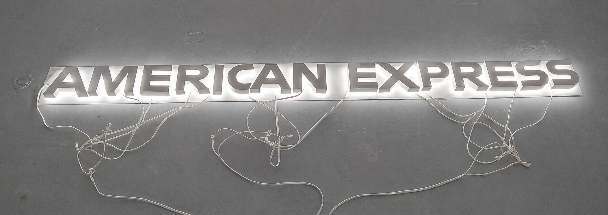Close-up of a white American Express halo-lit letter during fabrication