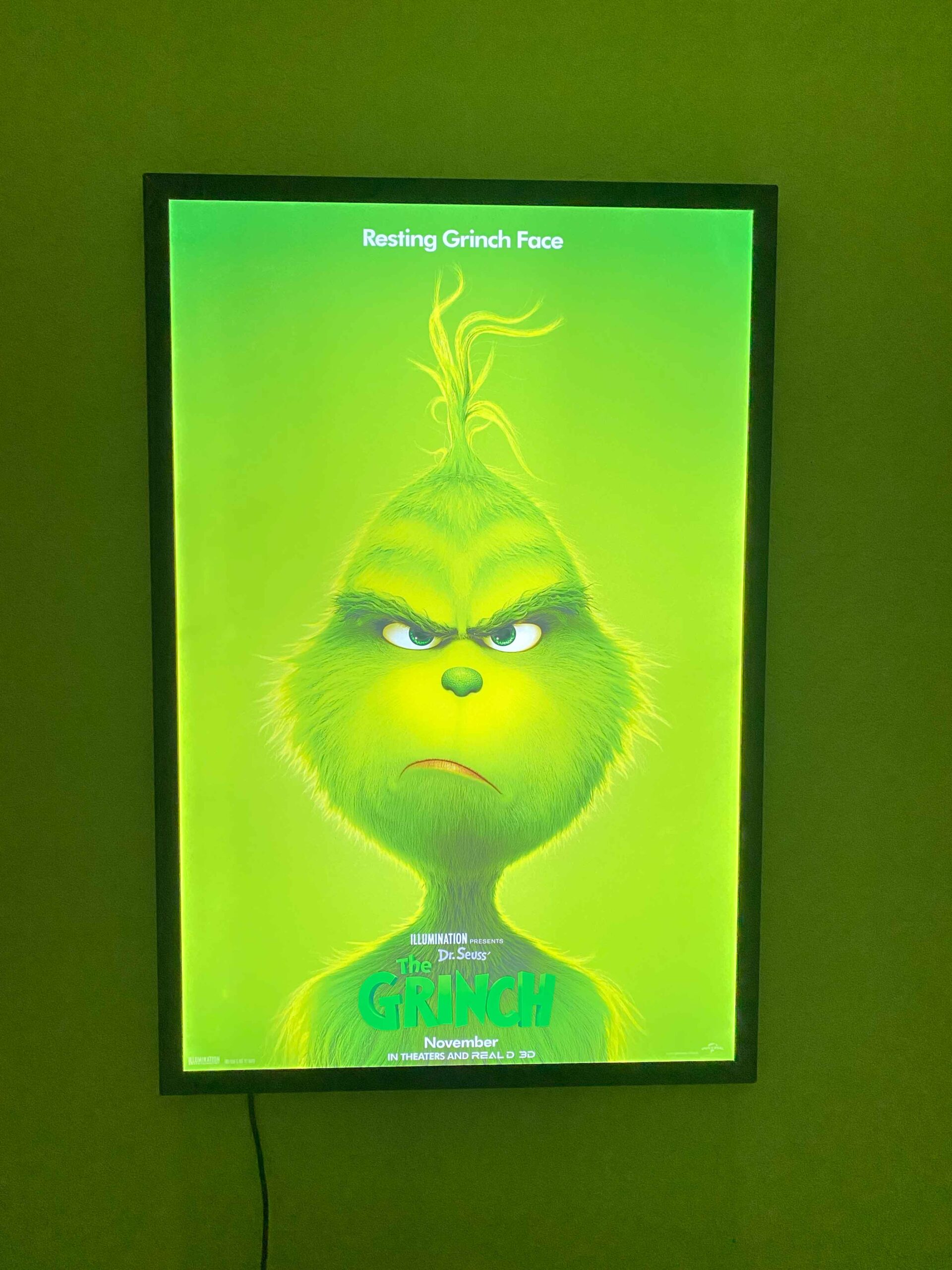 Green movie poster displayed in a wall-mounted home theater LED frame