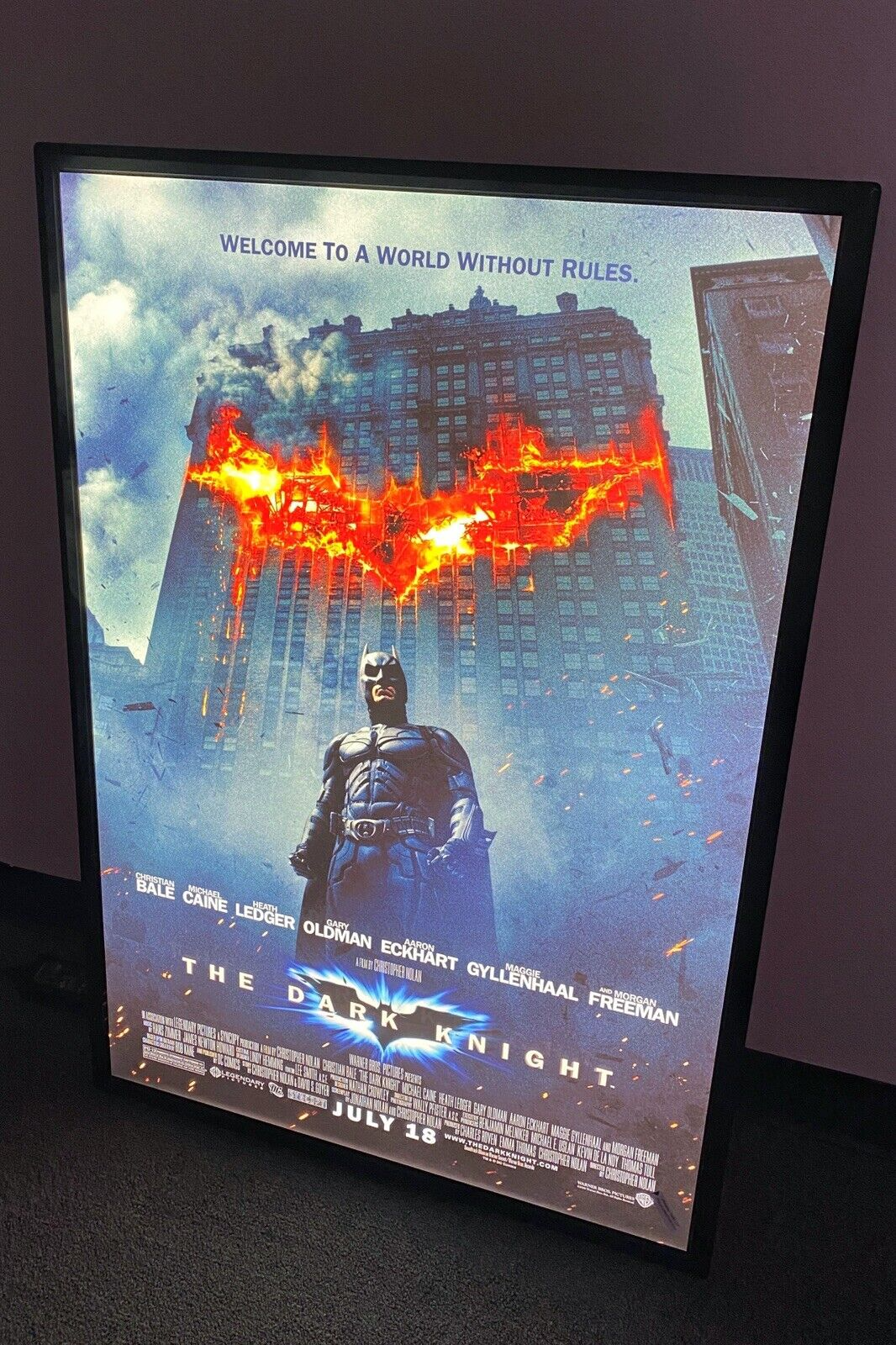 Illuminated movie poster frame used as home theater wall decor