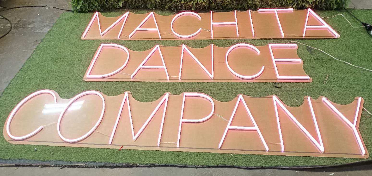 Machita Dance Company custom pink LED neon sign laid out during production