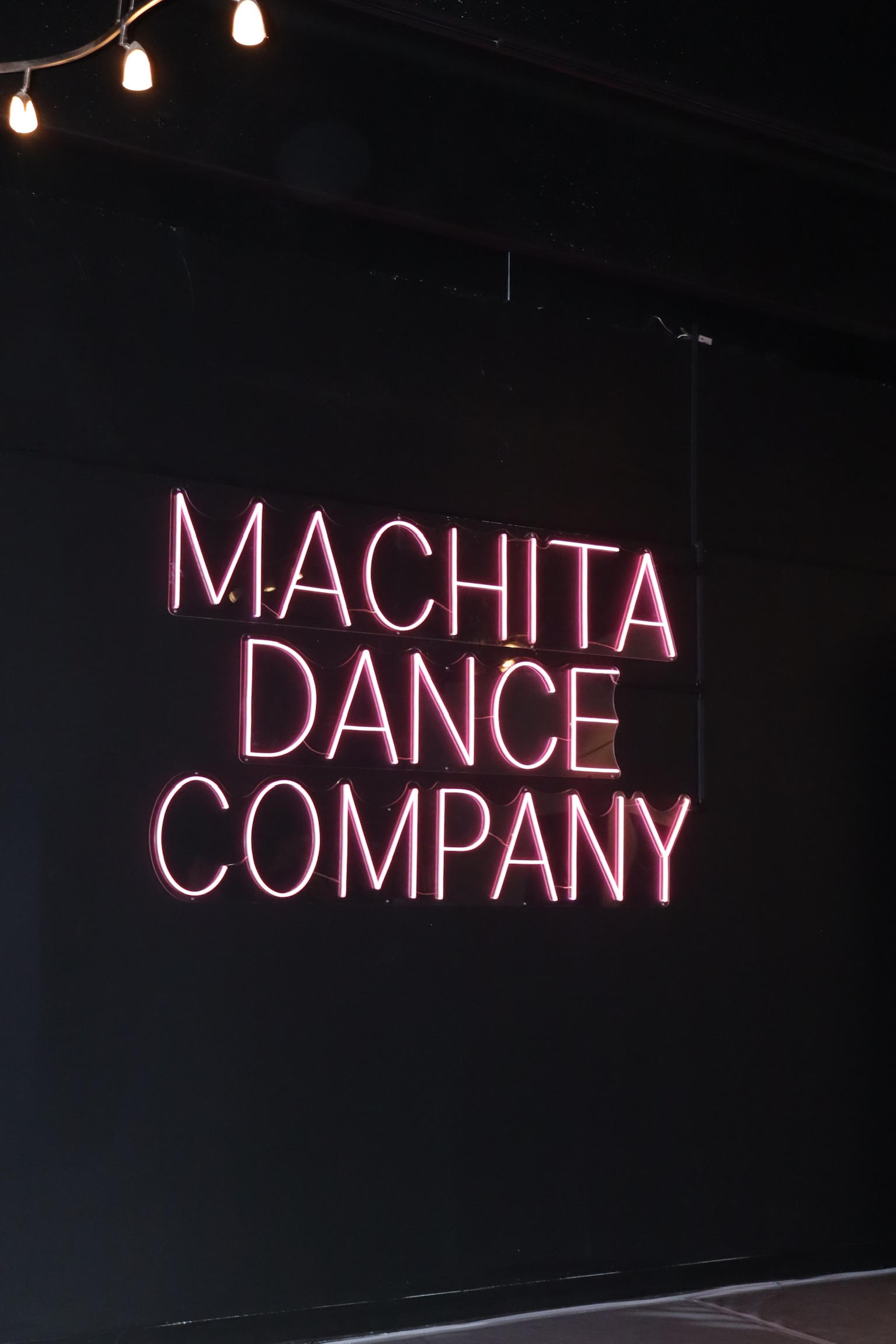 Custom pink LED neon sign installed at Machita Dance Company