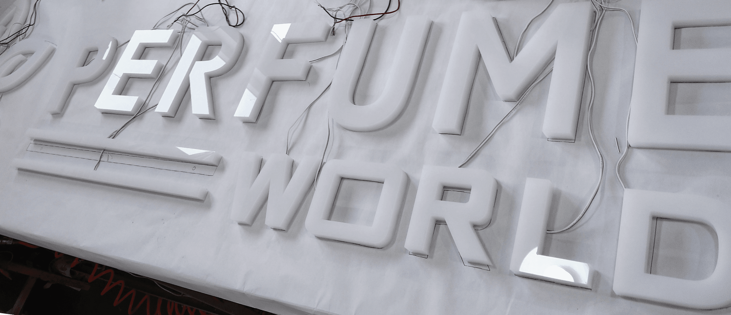 Perfume World acrylic LED letters during fabrication and wiring