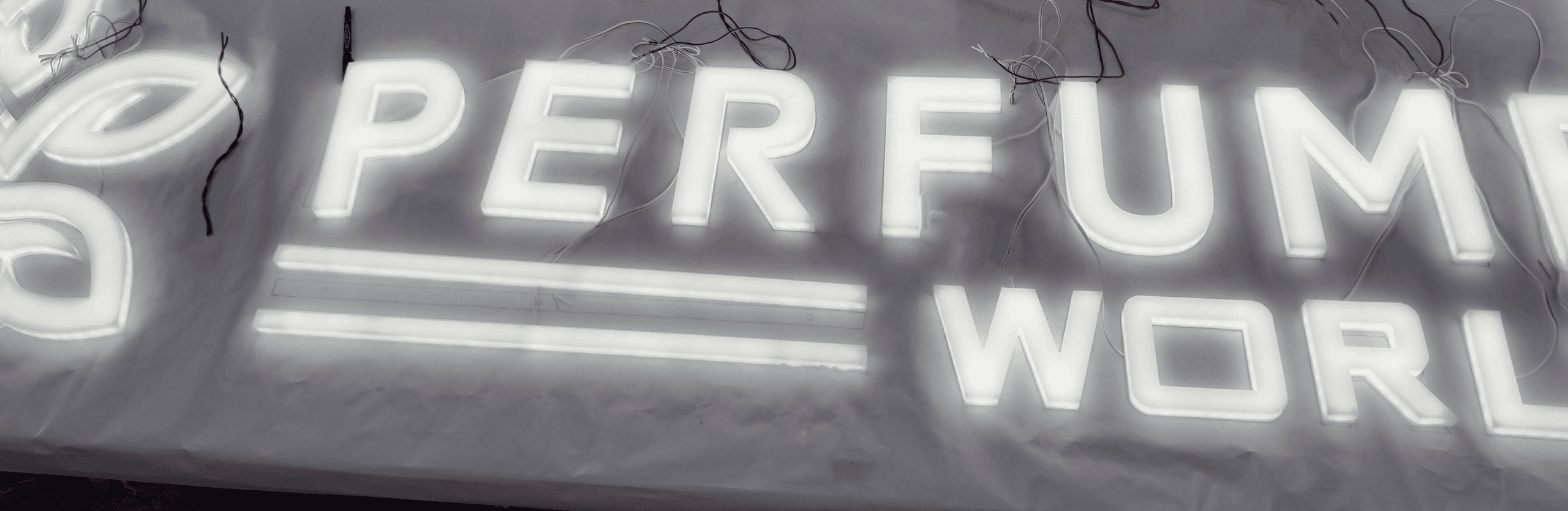 Perfume World acrylic LED letters illuminated during workshop testing
