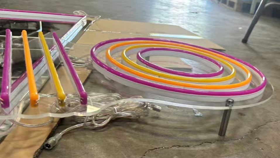 Close-up of multicolor Studio 7 LED neon tubing mounted on a mirrored acrylic backer