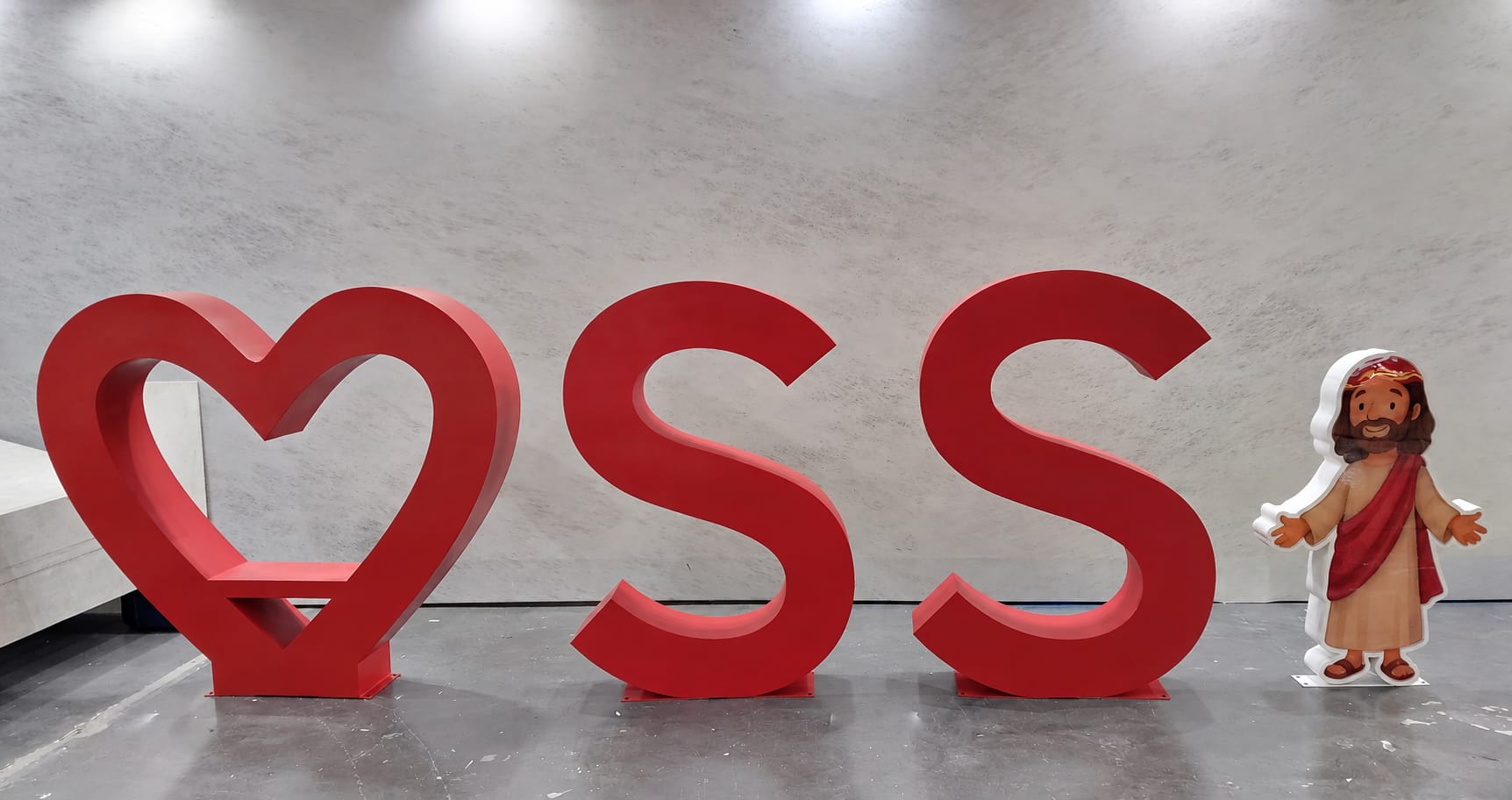 Sacred Heart oversized outdoor letters in a wide exterior installation view