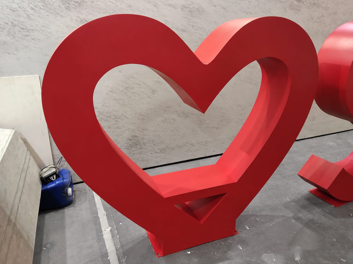 Close-up of the heart-shaped letter in the Sacred Heart outdoor sign