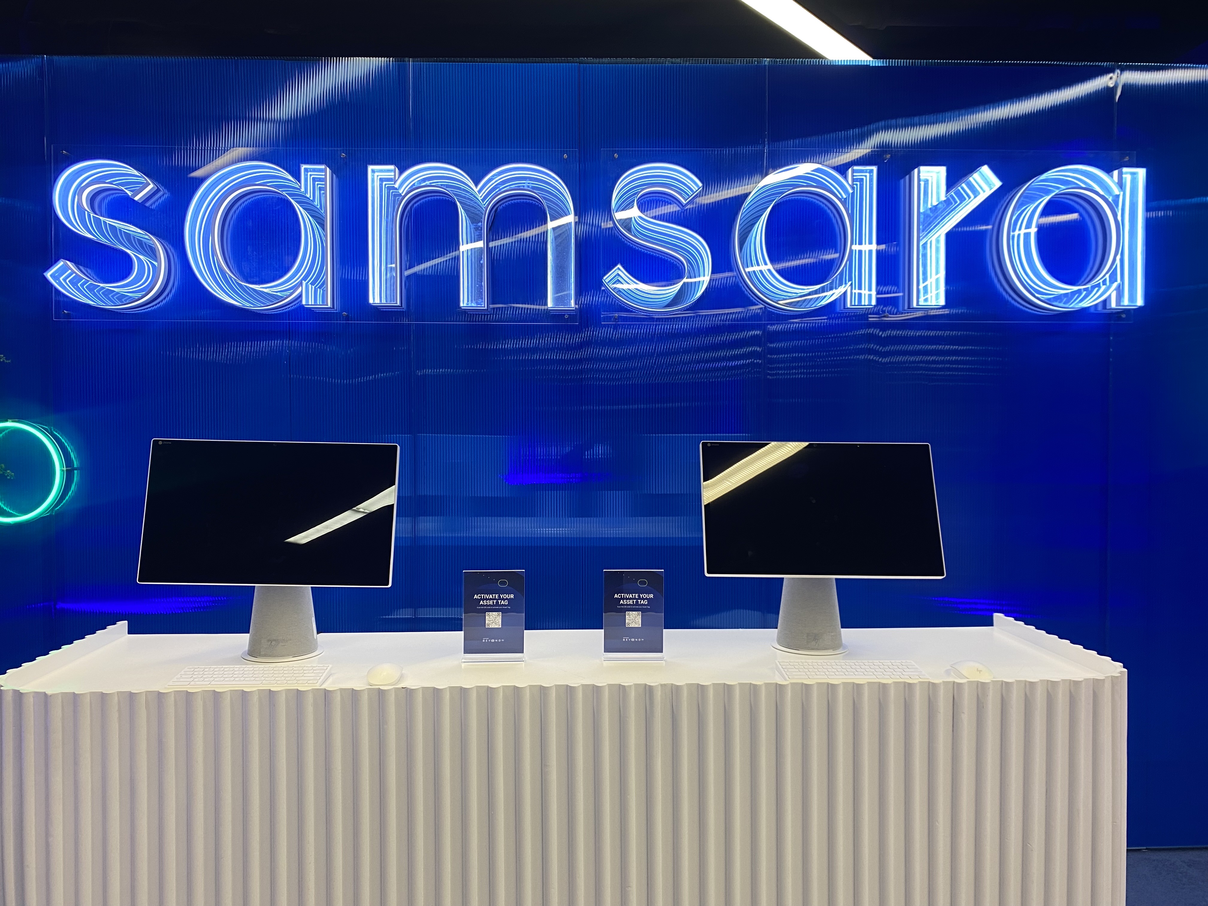 Close-up of illuminated Samsara infinity channel letters on a blue backdrop