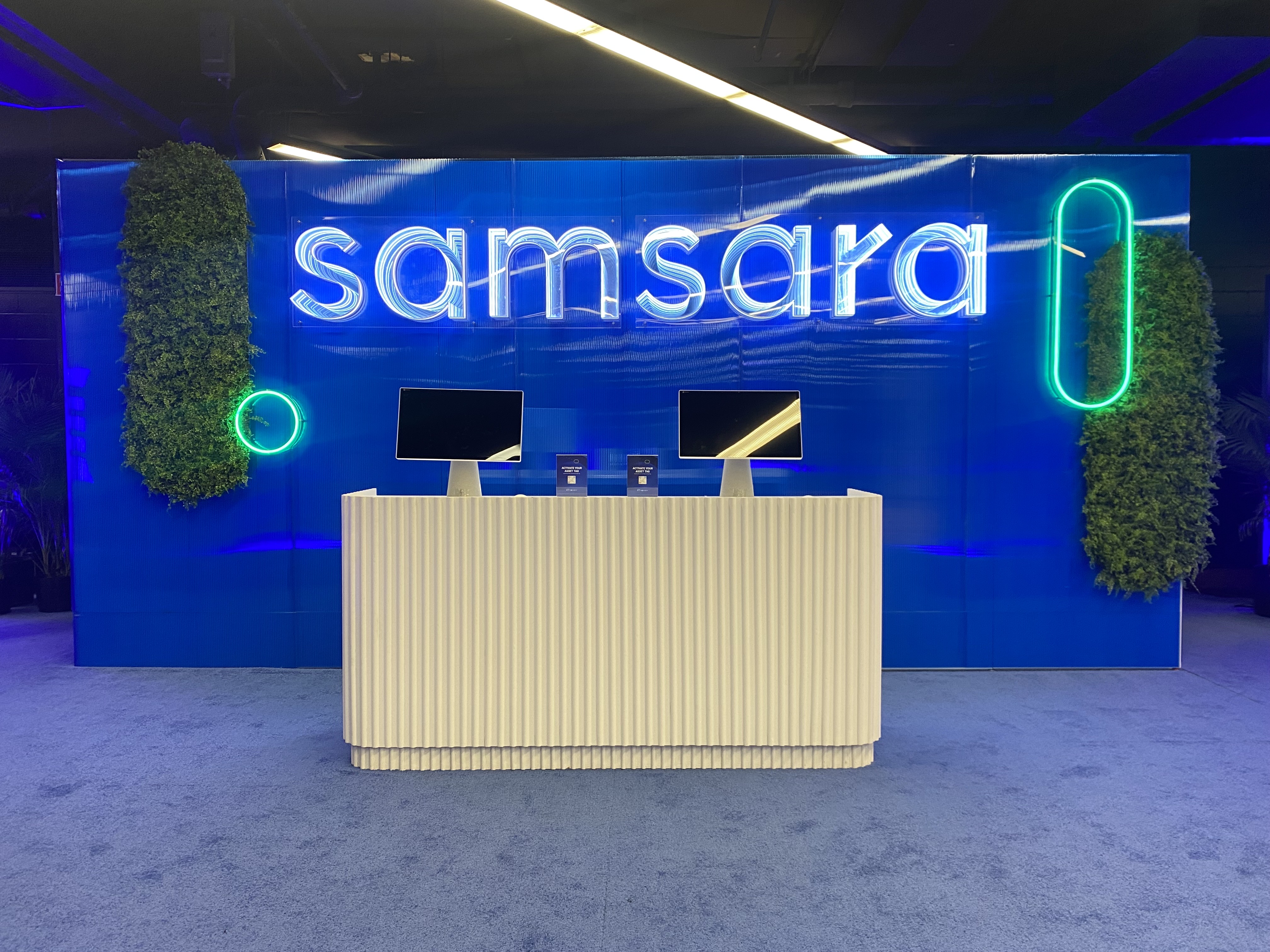 Samsara infinity channel letters on a blue event backdrop